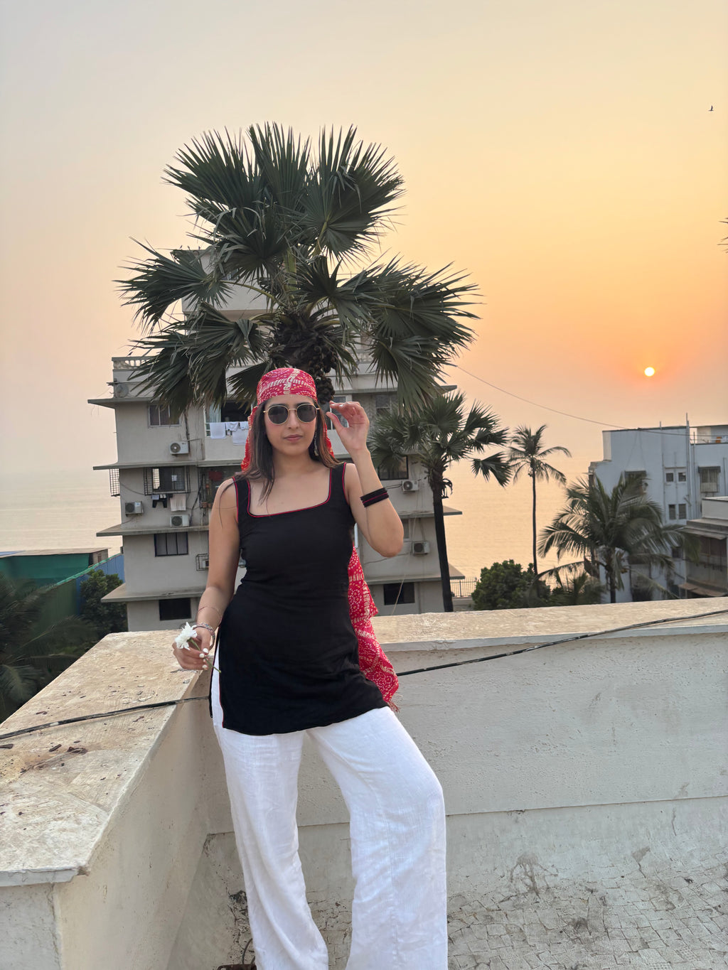 Bindee Black Tank top kurti styled with a red dupatta and sunglasses